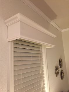 a window with white shutters in a room