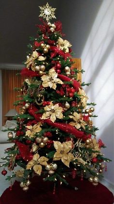 a christmas tree with gold and red decorations