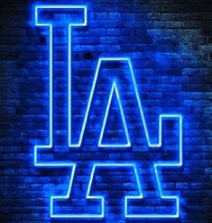 the los angeles dodgers logo is lit up in blue