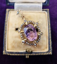 Antique Edwardian openwork 9ct Gold pendant, circa 1901 -1910, set with natural split pearls around a decorative border with a pearl set bale. The star of the show is a beautiful oval cut amethyst, it is a gorgeous shade of lavender purple.  Pendant: 35mm x 20mm inclusive of bale Amethyst: 14mm x 9mm Hallmark: Unmarked, tests as 9ct gold Weight: 3.2g The birthstone for February, this instantly recognisable gemstone has never declined in popularity. It's history dates back to Ancient Greece, they Unique Jewelry Vintage, Victorian Pendants, Mary Queen Of Scots, Decorative Borders, Fancy Jewellery, Amethyst Jewelry, Pearl Set, Amethyst Pendant, Ancient Greece