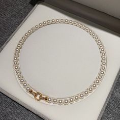 Elevate any outfit with our Classic Round Pearl Necklace for Women! This stunning necklace is the perfect gift for the special woman in your life. The timeless design boasts a round pearl that will add a touch of elegance and sophistication to any look. Show her how much she means to you with this beautiful necklace. Color: White, GrayMaterial: 18K White Gold Plated Copper Stone: Cubic ZirconiaPearl: High Quality Artificial Round PearlPearl Size: 8mm~9mmLength: 45cm ~ 17InchThis necklace is made of 8mm round pearls, which are strung on a silk thread. The pearls are a classic white color and have a high luster. The necklace is 18 inches long and has a sterling silver clasp. Classic Pearl White Necklace With Clavicle Chain, Pearl White Round Pearl Necklace, Pearl White Clavicle Chain Necklace, Pearl Clavicle Chain Necklace, Classic Round Pearl Necklace With Clavicle Chain, Stunning Necklace, Beautiful Necklace, Silk Thread, Pearl Size