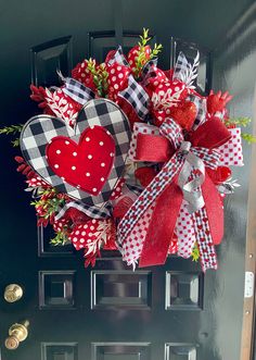 a red and white heart wreath on the front door