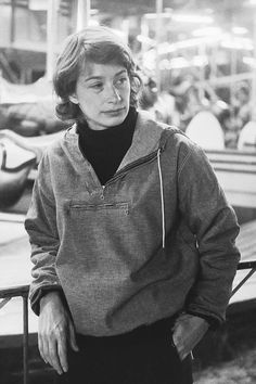 black and white photograph of a woman leaning against a rail