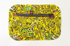 a yellow and black purse with various doodles on the front, along with words that spell out dance