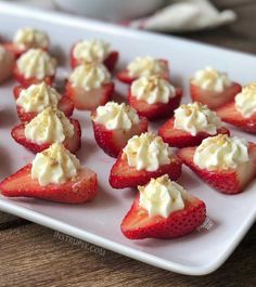 strawberries with whipped cream are on a white plate, ready to be eaten and served