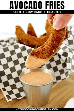 a person dipping some food into a small cup