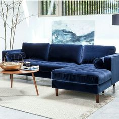 a living room with a blue couch and coffee table