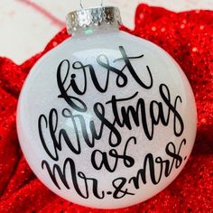 a glass ornament with the words first christmas as mr and mrs on it