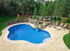 a backyard with a swimming pool and fire pit