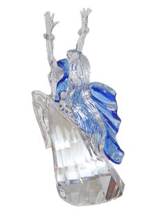 a blue glass figurine sitting on top of a crystal base