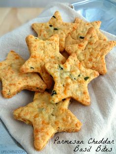 cheesy crackers with parmesan cheese and basil on a napkin in a bowl