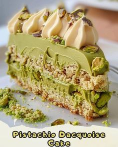 there is a piece of cake with green frosting on the top and pistachio sauce on the bottom