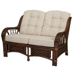 a wicker loveseat with cushions on it