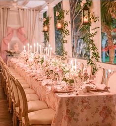 a long table is set with flowers and candles for a formal dinner or function in the dining room