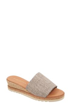 A cork-covered midsole and jute-wrapped wedge lend visual intrigue to an espadrille-inspired slide sandal set on a cushioned footbed for all-day comfort. 1 3/4" heel; 1/2" platform Cushioned footbed Textile upper/leather lining/synthetic sole Made in Spain Beach Straw Wedge Sandals With Cork-bed Midsoles, Beige Straw Wedge Sandals With Textured Sole, Beige Wedge Sandals With Cork-bed Midsoles And Round Toe, Vacation Espadrille Wedge Sandals With Textured Sole, Vacation Wedge Sandals With Textured Sole, Beige Wedge Espadrilles With Textured Sole, Beach Espadrilles With Textured Wedge Heel, Straw Wedge Sandals With Textured Footbed, Straw Open Toe Wedge Sandals With Textured Footbed