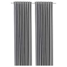 pair of grey curtains with metal rods on the top and bottom, in front of a white background