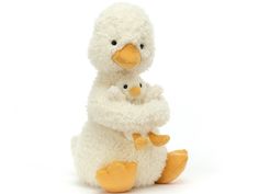 a stuffed duck with its baby in it's arms