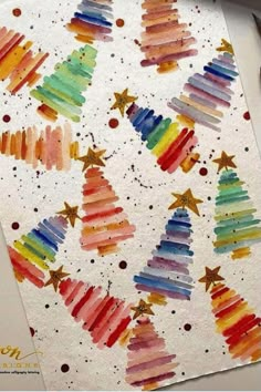 watercolor christmas trees are painted on white paper