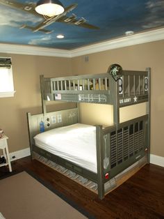 a bedroom with a bunk bed and ceiling painted to look like a star wars theme