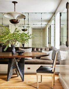 a living room filled with furniture and a wooden table in front of a mirror on the wall