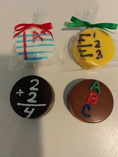 three decorated cookies sitting on top of a table