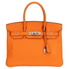 Hermès 30cm Birkin bag in orange taurillon clemence leather and palladium hardware. Handle drop, 3"L. Includes clochette, tirette, lock, keys and original dust bag. Date stamp Q in a square for 2013. Prince Rainier, Date Stamp, Birkin 30, Hermes Birkin 30, Jane Birkin, Grace Kelly, Handle Bag, Hermes Birkin, Birkin Bag