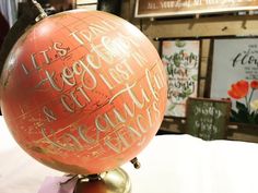 an orange and gold globe with writing on it