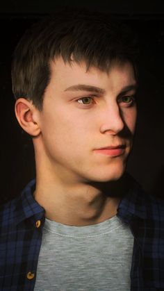 a close up of a person wearing a shirt and looking at the camera with an intense look on his face