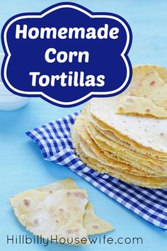 homemade corn tortillas stacked on top of each other with a blue and white checkered napkin