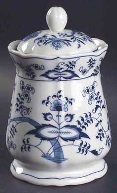 a blue and white sugar bowl with a lid