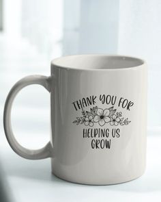 a white coffee mug with the words thank you for helping us grow