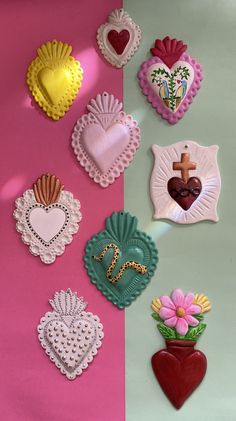 several heart shaped cookies on a pink and green background