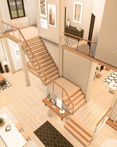 an aerial view of a living room with stairs leading up to the second floor area