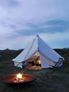 a tent with a fire pit in front of it