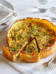 a quiche on a white plate with silverware