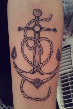 an anchor and rope tattoo on the arm