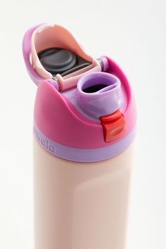 a pink and purple water bottle with a toothbrush in the cup on it's lid