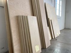 plywood boards are lined up on the floor