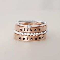 THIS INCLUDES ALL OF THE RINGS IN THE FIRST PHOTO - two 3mm name rings (14k rose gold filled)  - a 1 sterling silver birthstone ring - a 2 mm beaded sterling silver ring These are separate rings and can be put in any order FOUR total rings...we recommend sizing up half a size to accommodate for multiple rings. We recommend sizing up half a size to accommodate all of the rings. Adjustable Rose Gold Stackable Birthstone Ring, Custom Name Rose Gold Ring, Adjustable Stackable Rose Gold Birthstone Ring, Stacked Rings For Anniversary, Custom Name Rose Gold Ring Jewelry, Custom Name Rose Gold Promise Ring, Custom Name Rose Gold Jewelry For Promise Ring, Rose Gold Custom Name Jewelry For Promise, Custom Name Stackable Rose Gold Promise Rings