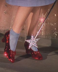 a close up of a person's red shoes with a star on the heel