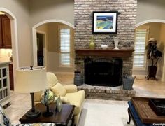 a living room filled with furniture and a fire place