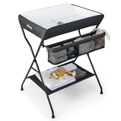 a black and white baby changing table with two baskets