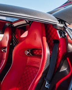 the interior of a sports car with red leather and chrome trims, including an open door