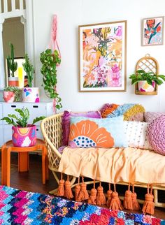 a living room filled with lots of colorful pillows