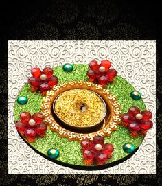 a decorative plate with a donut on it and red flowers in the center, surrounded by green grass