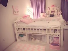 a white bunk bed sitting next to a window with purple curtains and teddy bears on it