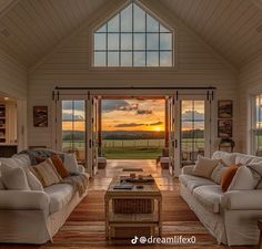 a living room filled with furniture and windows