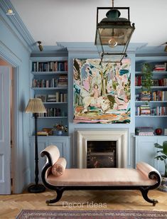 a living room filled with furniture and a fire place in front of a book shelf