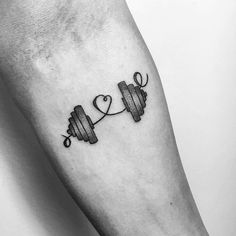 a black and white photo of a couple of dumbs on the arm with a heart