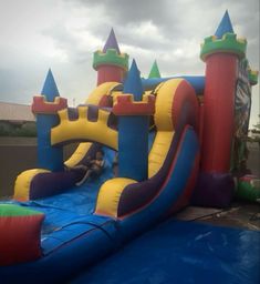 a bouncy castle with slide in the background